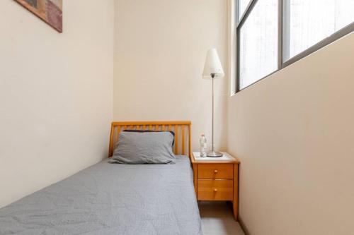 a small bedroom with a bed and a window at Mexico City MondoMexico Deluxe 2 Bedroom apartments in Mexico City
