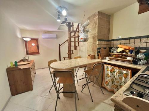 a kitchen with a table and chairs in a room at Il Vecchio Borgo in San Donato Val di Comino