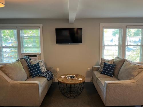 a living room with two couches and a tv at Abalonia Inn in Ogunquit