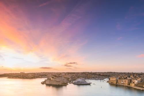 a view of a river with boats in a city at Authentic Maltese Boutique Holiday Home with Rooftop Pool - Moon Townhouse in Cospicua