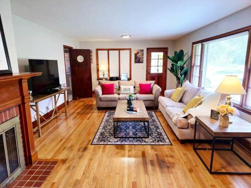 a living room with a couch and a table at Charming Retreat in the heart of Burlington in Burlington