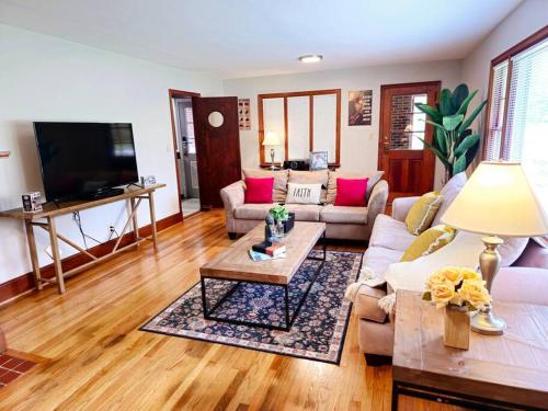 a living room with a couch and a table at Charming Retreat in the heart of Burlington in Burlington