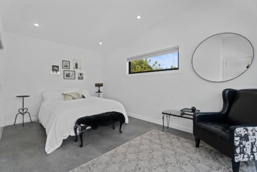 a bedroom with a bed with a black dog on it at Caledonia - Earnscleugh Holiday Home in Earnscleugh