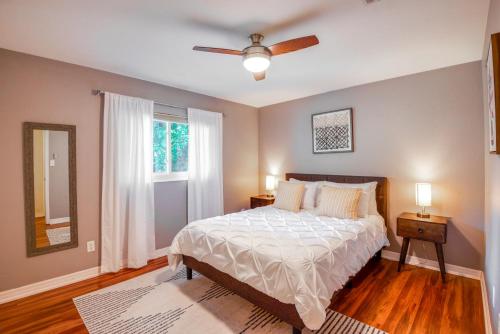 a bedroom with a bed and a ceiling fan at Pet-Friendly Home - 3 Mi to University of Florida! in Gainesville