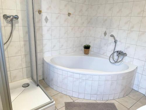 a bathroom with a tub with a plant in it at Ferienhaus-Haus-Eversand in Cuxhaven