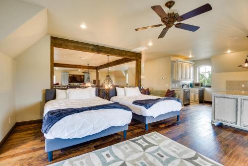 a bedroom with two beds and a ceiling fan at Spacious Edmond Vacation Rental with Hot Tub! in Edmond