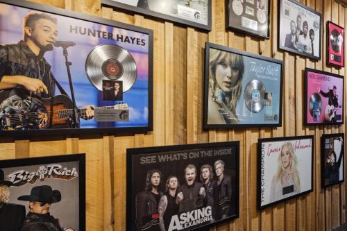 a wall with posters and pictures on it at Charming Bunkhouse at Dark Horse Estate in Franklin