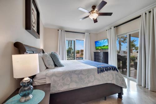 a bedroom with a bed and a ceiling fan at Casa Sirena Cabo Poolside Oasis Minutes from Beach in Cabo San Lucas