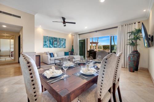 a dining room and living room with a table and chairs at Casa Sirena- Secure & Private Poolside Retreat in Cabo San Lucas