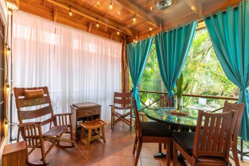 a dining room with a table and chairs and a window at Namaste Beach Bungalow 1 BDR Loft 4 Min to Beach in Nosara