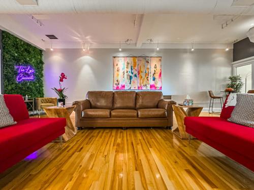 a living room with a couch and wooden floors at The Historic Lyric Penthouse with Private Rooftop in Cincinnati