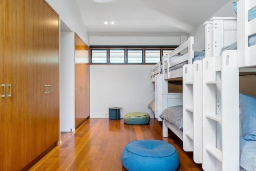 a bedroom with two bunk beds and a large window at Yangaro in Airlie Beach