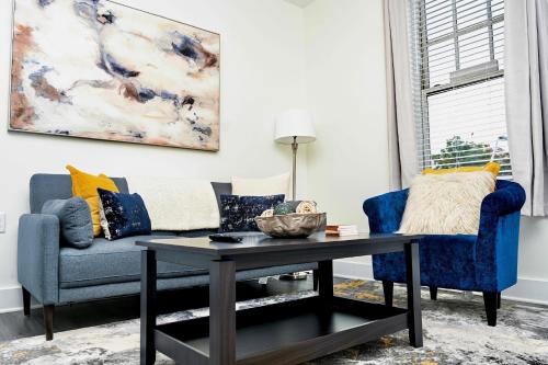 a living room with a couch and a table at Less than 1mi to Little Caesars Arena, 2BR with Free Parking in Detroit
