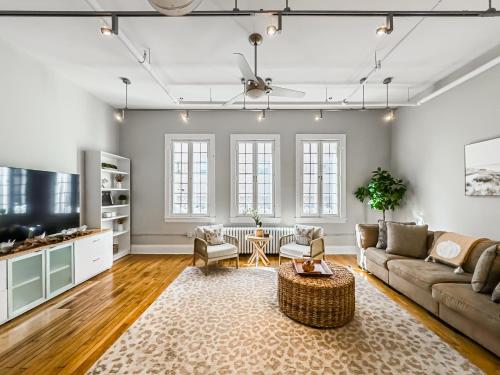 an open living room with a couch and a tv at The Historic Lyric Presidential Suite in Cincinnati