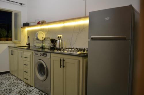 a kitchen with a refrigerator and a washing machine at Appartement chic et beldi à 10 minutes du centre in Essaouira