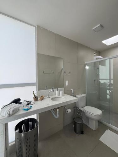 a bathroom with a sink and a toilet at Casa G9 - Naluum Residence in Passo de Camarajibe