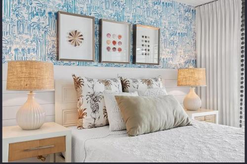 a bedroom with a bed with blue and white wallpaper at Dolphin Getaway in Marco Island