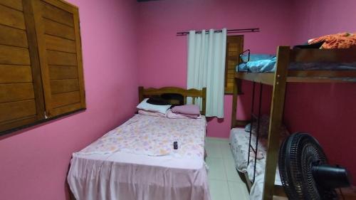 a small bedroom with a bed and a bunk bed at Sitio Santo Antonio in Tutóia