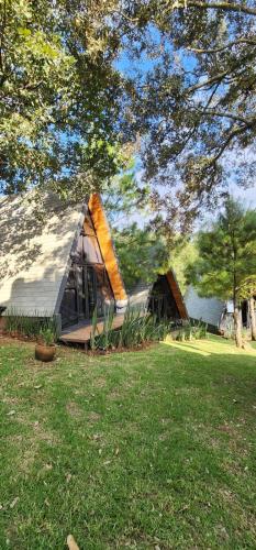 a large tent sitting in a field next to a lake at Cabañas Siete Puntas in Mazamitla