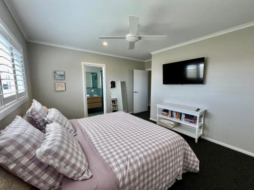 a bedroom with a bed and a flat screen tv at Foxhill Shores - WIFI outside pets in Robe