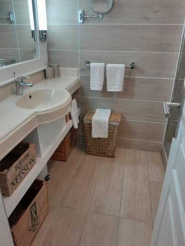 a bathroom with a sink and a mirror at Studio O'PALM in Sainte-Luce