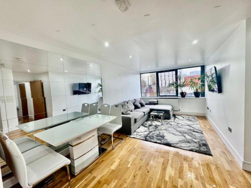 a living room with a couch and a table at Luxury 2 BED Entire Apartment-Near Tube & Shopping centre in Harrow