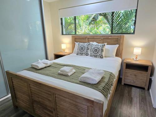 a bedroom with a large bed with two towels on it at Noosa River Retreat Holiday Apartments in Noosaville
