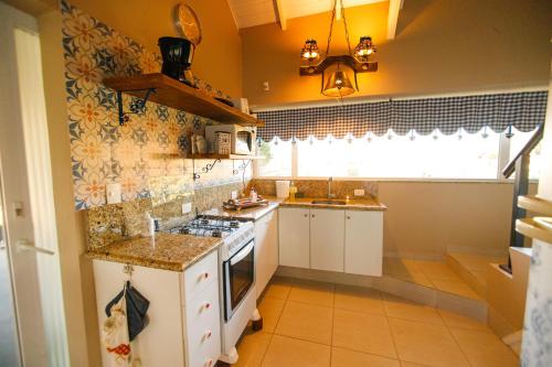a kitchen with a sink and a stove top oven at Rancho P&R in Balsa Nova