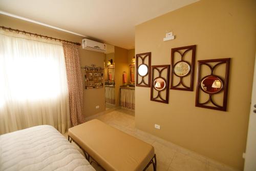 a bedroom with a bed and some pictures on the wall at Rancho P&R in Balsa Nova
