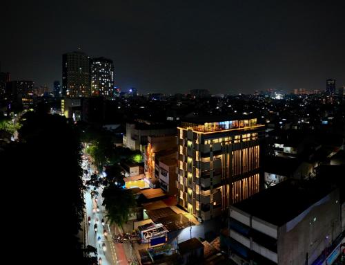 a view of a city at night with buildings at Mimaru Hotel Jakarta Mangga Besar in Jakarta