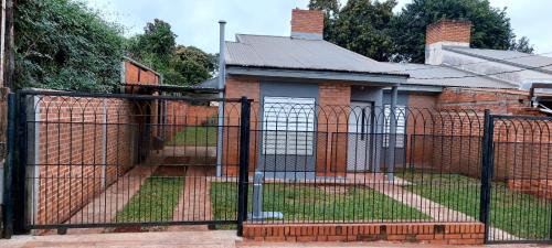 a wrought iron fence in front of a house at Araucaria in Puerto Esperanza