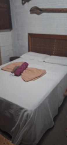 a large white bed with two towels on it at Espaço Sairé - 8 minutos da Praia in Alter do Chao