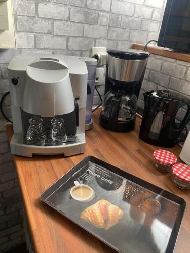 a coffee maker on a counter with a tray of food at La Ptite maison du Canal in Drevant