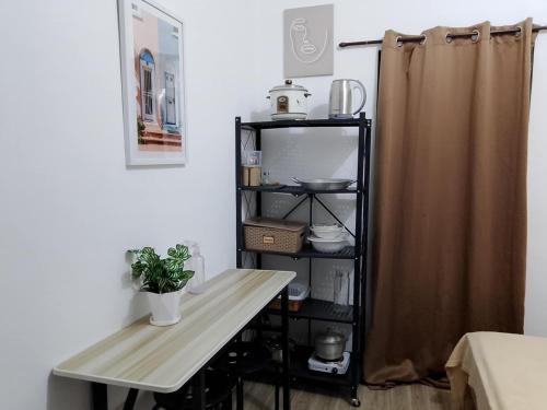 a table and a shelf in a room with a desk at NON AIRCON STUDIO TYPE UNIT Salvacion Palo Room 9 in Palo