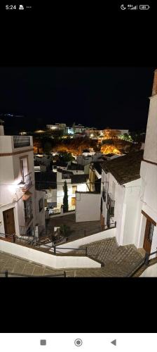 a view of a city at night with buildings at Apartamento El Patio. in Setenil