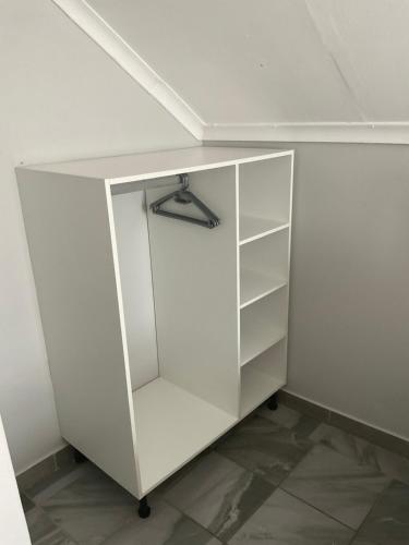 a white cupboard in a corner of a room at Riverside Recreation Lodge in Katima Mulilo