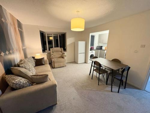 a living room with a couch and a table at Two bed spacious apartment, central location, free parking and Wifi in Birmingham