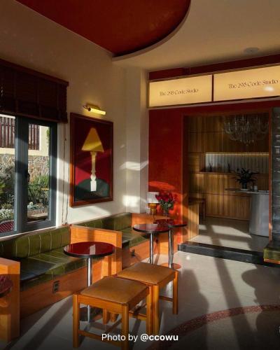a lobby with tables and chairs in a building at Hôtel De Da Phu in Da Lat