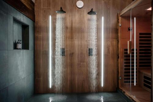 a bathroom with a shower with wooden walls at South Causey Inn in Stanley