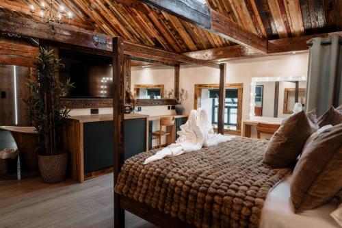a bedroom with a bed in a room with a kitchen at South Causey Inn in Stanley
