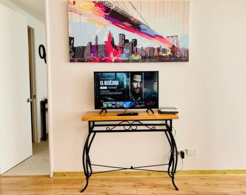 a desk with a computer on it in a room at Portada VIP in La Chimba