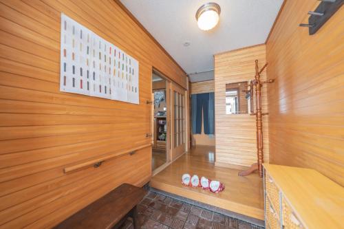 Shimo-furanoにあるRental Whole House Motomachiの木製の壁の客室で、ベンチが備わります。