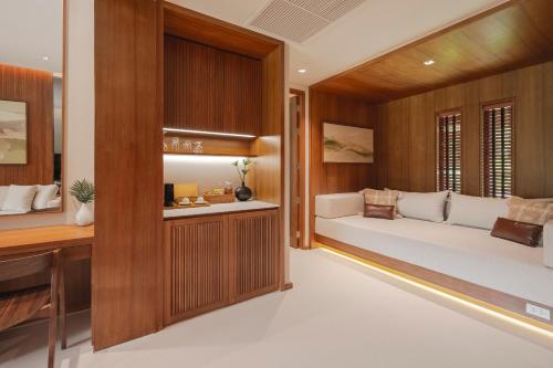 a living room with a couch in a room at Kirimaya Golf Resort Spa - SHA Plus Certified in Mu Si