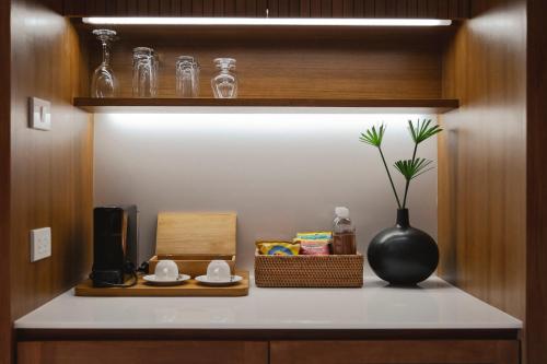 a shelf with a vase on a counter in a kitchen at Kirimaya Golf Resort Spa - SHA Plus Certified in Mu Si