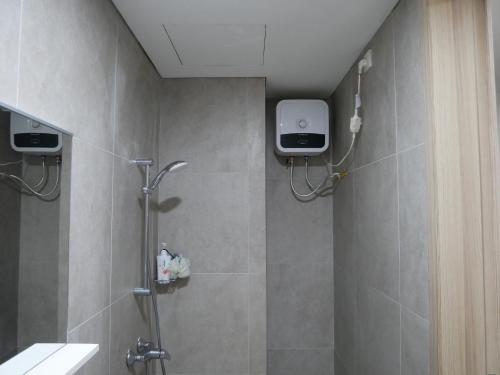 a bathroom with a shower stall with a shower at Meisterstadt Pollux Habibie in Batam Center