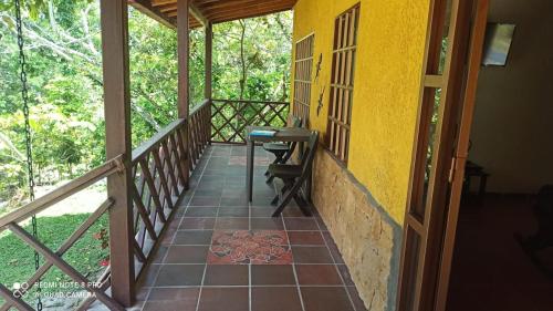 a balcony of a house with a desk on it at Cabaña MACAREGUA - Curití Santander in Curití