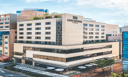 an external view of a building with a sign on it at Wonju City Hotel HYEOKSIN in Wonju