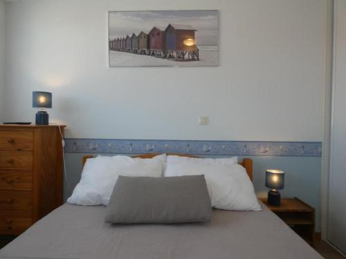 a bedroom with a bed with two lamps and a picture on the wall at Notre Dame de Monts (85) - Location Appartement 50m² environ - 6 personnes - FR-1-540-4 in Notre-Dame-de-Monts