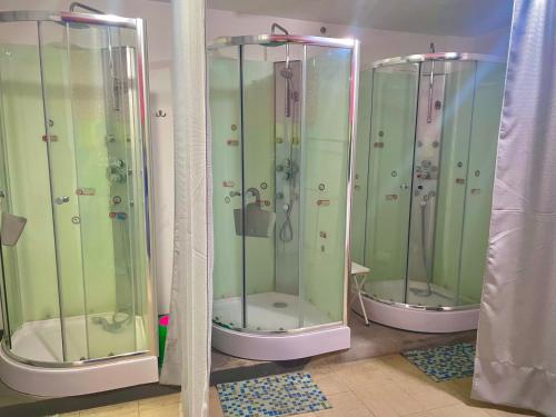 a group of four shower stalls in a room at Tajmani Hostel Arequipa in Arequipa