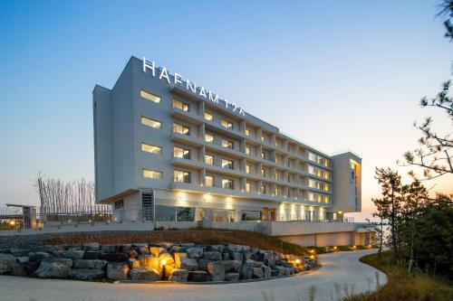 a hotel building with a fire place in front of it at Haenam 126 Hotel in Haenam